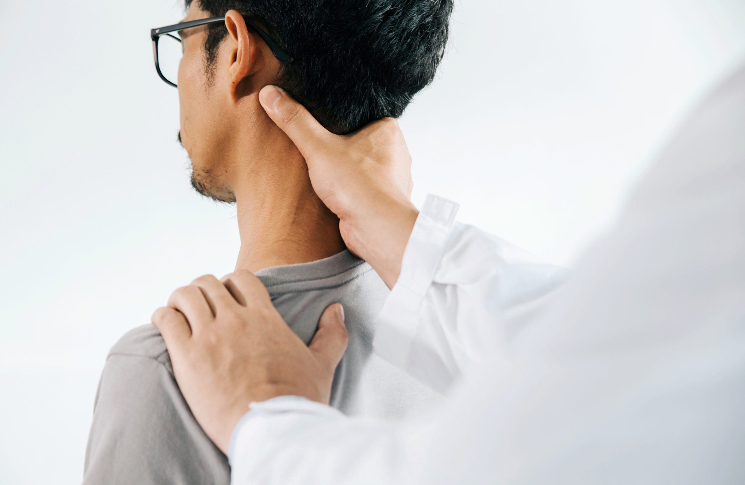Man massaging his neck due to pain.